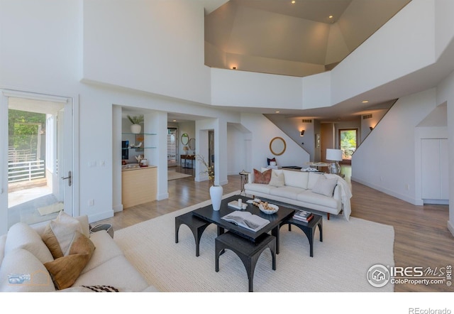 3747 Mountain Laurel Pl, Boulder, CO 80304 - living room with light wood-style flooring, a towering ceiling, stairway, and recessed lighting
