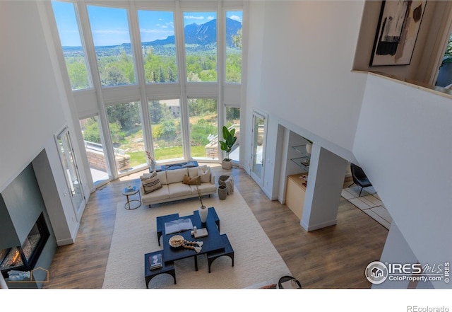 3747 Mountain Laurel Pl, Boulder, CO 80304 - living area featuring a towering ceiling, wood finished floors, and a mountain view