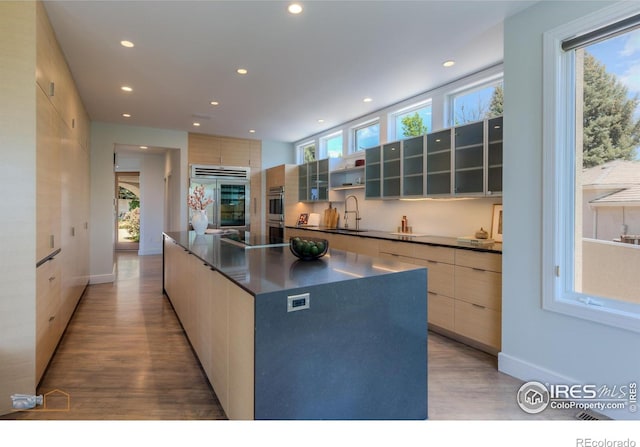 3747 Mountain Laurel Pl, Boulder, CO 80304 - kitchen featuring high quality fridge, modern cabinets, dark countertops, light wood finished floors, and recessed lighting