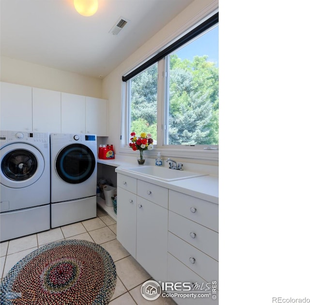 3747 Mountain Laurel Pl, Boulder, CO 80304 - laundry room with separate washer and dryer, cabinet space, and light tile patterned flooring