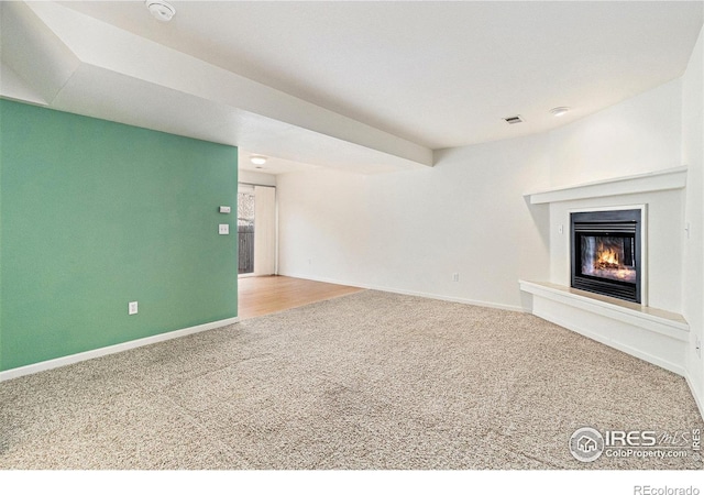 911 Tulip St Unit C, Longmont, CO 80501 - unfurnished living room with carpet floors and a glass covered fireplace