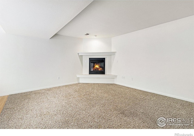 911 Tulip St Unit C, Longmont, CO 80501 - unfurnished living room with a glass covered fireplace and carpet floors