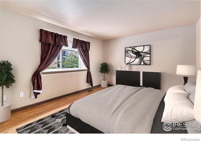 911 Tulip St Unit C, Longmont, CO 80501 - bedroom featuring wood finished floors and baseboards