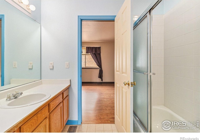 911 Tulip St Unit C, Longmont, CO 80501 - full bathroom with vanity, combined bath / shower with glass door, and tile patterned floors
