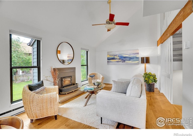 3880 Telluride Pl, Boulder, CO 80305 - living room with plenty of natural light, a wood stove, wood finished floors, and high vaulted ceiling
