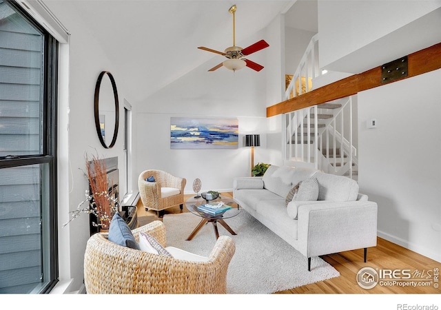 3880 Telluride Pl, Boulder, CO 80305 - living area featuring wood finished floors, stairs, a ceiling fan, and high vaulted ceiling