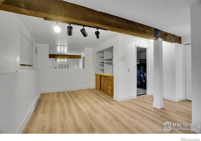 3880 Telluride Pl, Boulder, CO 80305 - empty room with a baseboard heating unit, wood finished floors, rail lighting, and beamed ceiling