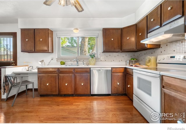 11198 W 59th Pl, Arvada, CO 80004 - kitchen featuring dishwasher, electric range, under cabinet range hood, and plenty of natural light