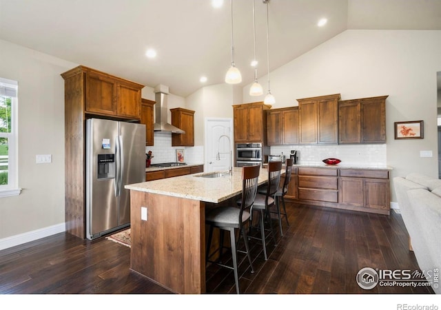 1327 Leahy Dr, Fort Collins, CO 80526 - kitchen with appliances with stainless steel finishes, wall chimney range hood, lofted ceiling, dark wood-style floors, and decorative backsplash