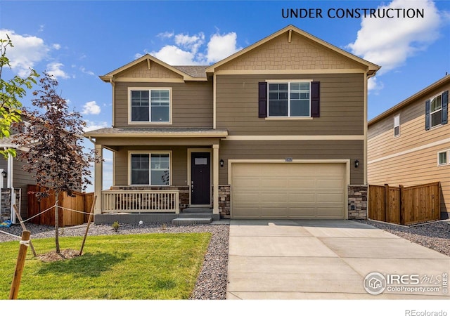 114 65th Ave, Greeley, CO 80634 - craftsman-style home featuring covered porch, an attached garage, driveway, stone siding, and a shingled roof