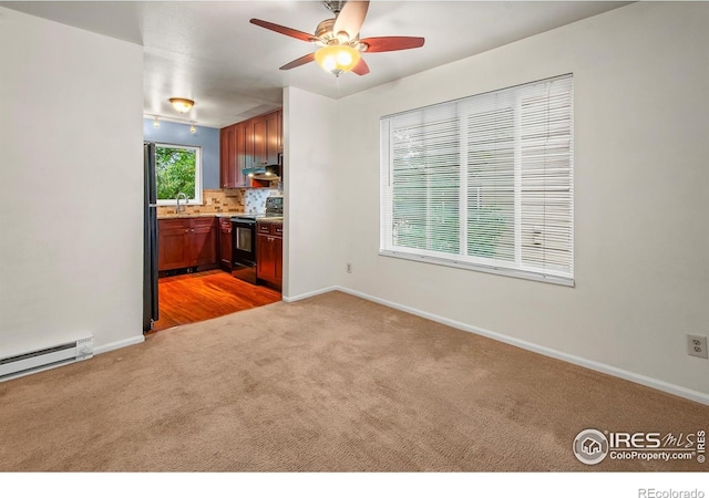 3465 Lochwood Dr Unit 91, Fort Collins, CO 80525 - kitchen featuring black / electric stove, light carpet, ceiling fan, tasteful backsplash, and baseboard heating