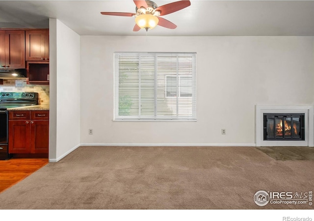 3465 Lochwood Dr Unit 91, Fort Collins, CO 80525 - unfurnished living room featuring carpet, a ceiling fan, and a glass covered fireplace