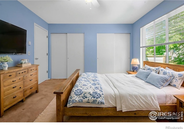 3465 Lochwood Dr Unit 91, Fort Collins, CO 80525 - bedroom featuring multiple closets, carpet, and ceiling fan