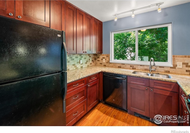 3465 Lochwood Dr Unit 91, Fort Collins, CO 80525 - kitchen featuring black appliances, light wood-style flooring, tasteful backsplash, and light stone countertops