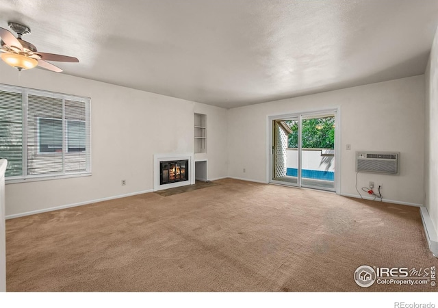 3465 Lochwood Dr Unit 91, Fort Collins, CO 80525 - unfurnished living room with carpet, ceiling fan, a wall mounted air conditioner, and a fireplace with flush hearth
