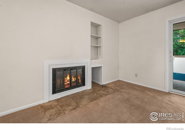 3465 Lochwood Dr Unit 91, Fort Collins, CO 80525 - unfurnished living room with a fireplace with flush hearth, carpet flooring, and built in features