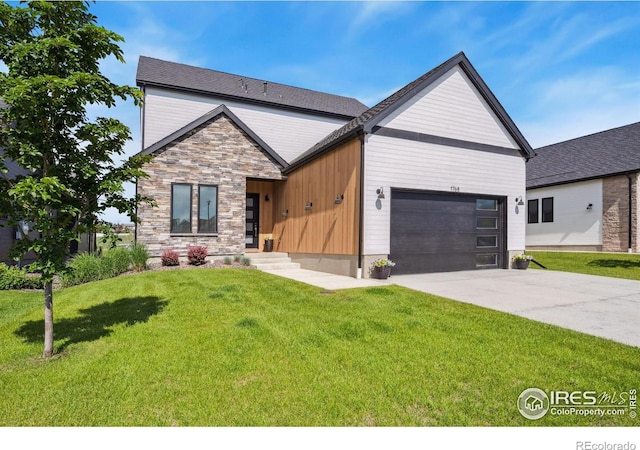 1768 Barefoot Dr, Windsor, CO 80550 - contemporary house featuring a garage, driveway, a front lawn, and stone siding