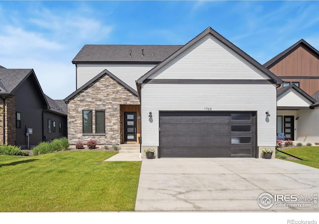 1768 Barefoot Dr, Windsor, CO 80550 - view of front of home with a garage, driveway, a front lawn, and stone siding