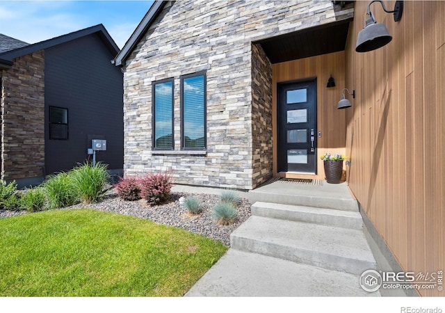 1768 Barefoot Dr, Windsor, CO 80550 - doorway to property featuring stone siding and a yard