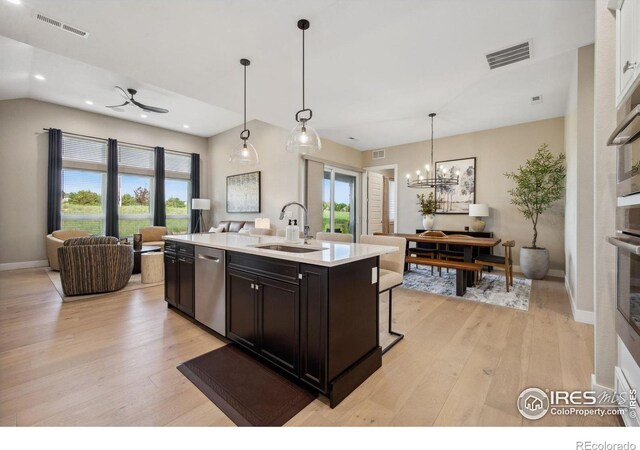 1768 Barefoot Dr, Windsor, CO 80550 - kitchen with stainless steel appliances, open floor plan, light wood-style flooring, light countertops, and healthy amount of natural light