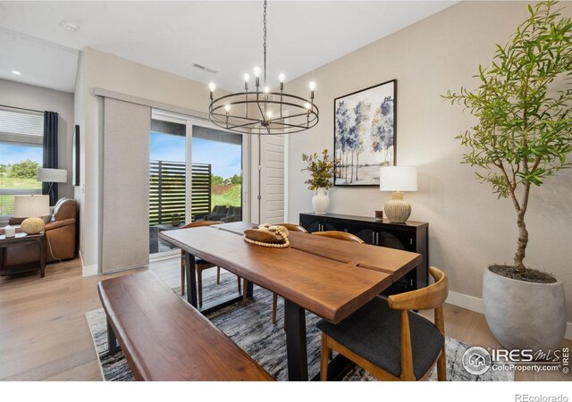 1768 Barefoot Dr, Windsor, CO 80550 - dining space with a chandelier, light wood-style floors, and plenty of natural light