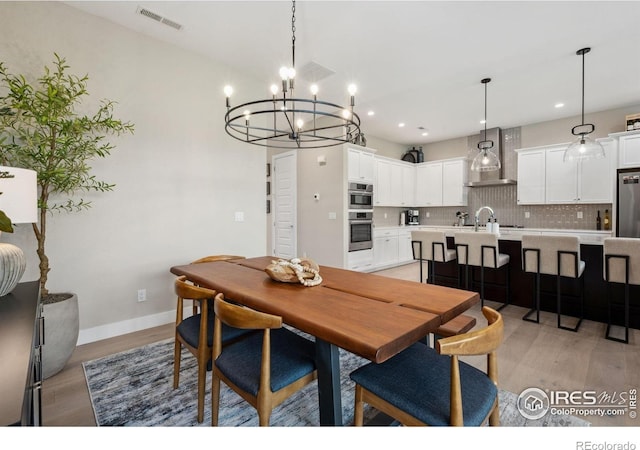 1768 Barefoot Dr, Windsor, CO 80550 - dining area with a chandelier, light wood finished floors, and recessed lighting