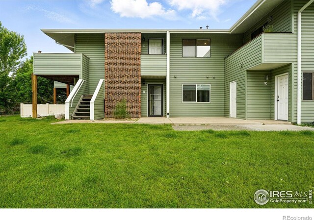 1900 Chalcis Dr Unit 42, Lafayette, CO 80026 - back of property with stairs, a patio, a yard, and a deck