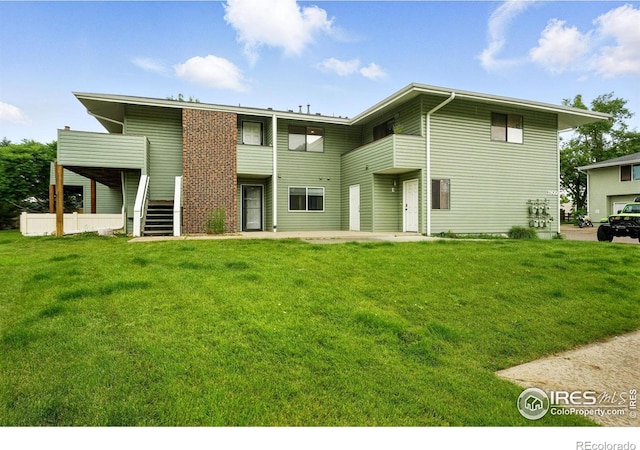 1900 Chalcis Dr Unit 42, Lafayette, CO 80026 - view of front of property with stairway, a front yard, and a patio