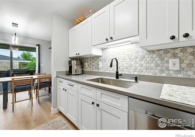 1900 Chalcis Dr Unit 42, Lafayette, CO 80026 - kitchen with stainless steel dishwasher, light wood finished floors, white cabinetry, and tasteful backsplash