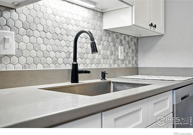 1900 Chalcis Dr Unit 42, Lafayette, CO 80026 - kitchen with backsplash, white cabinetry, stainless steel dishwasher, and light countertops