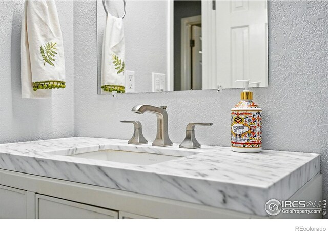 1900 Chalcis Dr Unit 42, Lafayette, CO 80026 - bathroom featuring a textured wall and vanity