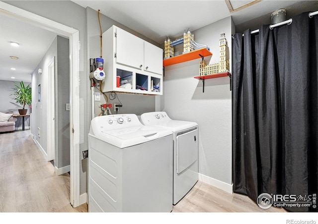 1900 Chalcis Dr Unit 42, Lafayette, CO 80026 - laundry area featuring independent washer and dryer, cabinet space, and light wood-style flooring