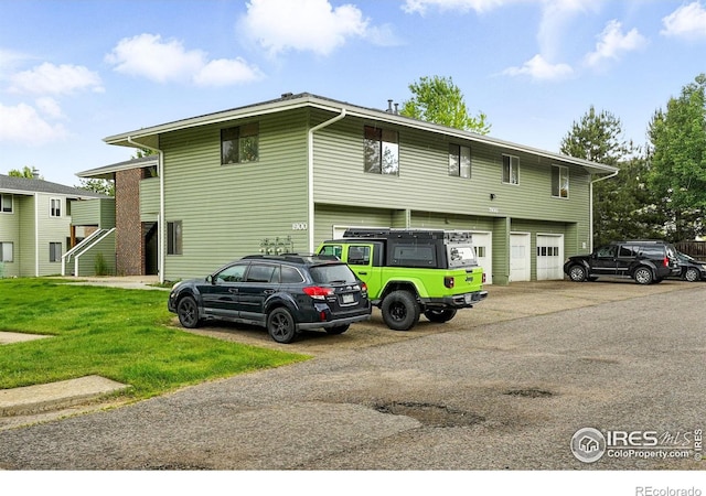 1900 Chalcis Dr Unit 42, Lafayette, CO 80026 - view of front of house with a garage, concrete driveway, and a front lawn