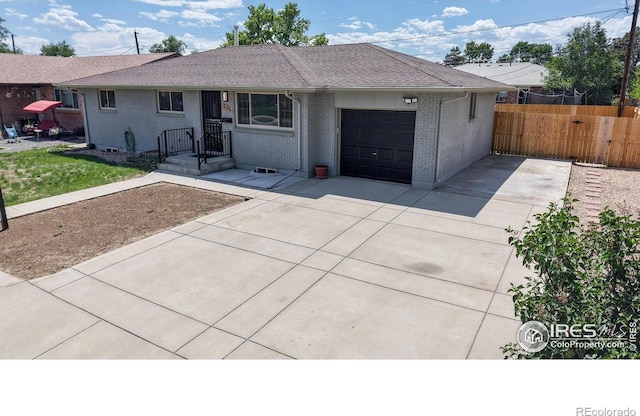 235 N 12th Ave, Brighton, CO 80601 - ranch-style house featuring an attached garage, concrete driveway, and brick siding