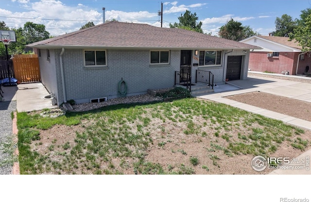 235 N 12th Ave, Brighton, CO 80601 - ranch-style home with concrete driveway, a garage, brick siding, and roof with shingles
