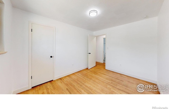 235 N 12th Ave, Brighton, CO 80601 - unfurnished bedroom with wood finished floors and baseboards