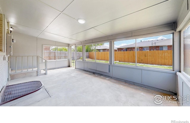 235 N 12th Ave, Brighton, CO 80601 - unfurnished sunroom featuring vaulted ceiling