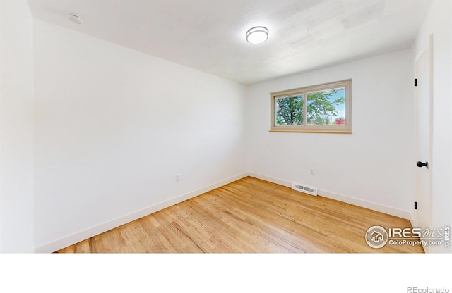 235 N 12th Ave, Brighton, CO 80601 - empty room featuring a smoke detector and wood finished floors