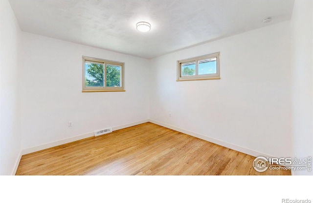 235 N 12th Ave, Brighton, CO 80601 - empty room featuring light wood-style floors and a smoke detector