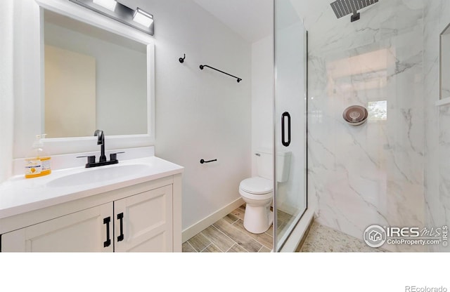 235 N 12th Ave, Brighton, CO 80601 - full bath with a marble finish shower, vanity, and wood finished floors