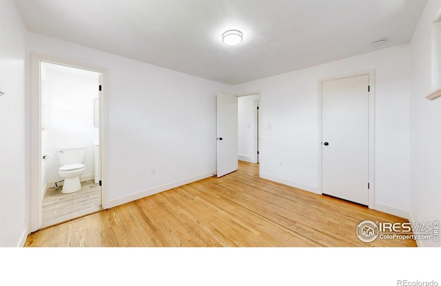 235 N 12th Ave, Brighton, CO 80601 - unfurnished bedroom with wood finished floors and ensuite bath