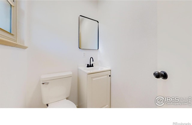 235 N 12th Ave, Brighton, CO 80601 - half bathroom featuring toilet and vanity