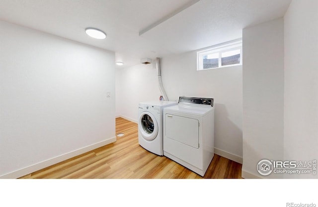 235 N 12th Ave, Brighton, CO 80601 - laundry area with washer and dryer and light wood-style floors