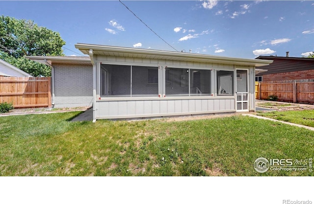 235 N 12th Ave, Brighton, CO 80601 - rear view of property featuring a sunroom