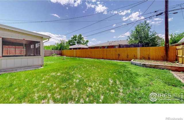 235 N 12th Ave, Brighton, CO 80601 - fenced backyard featuring a sunroom