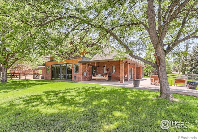 7975 Anchor Dr, Longmont, CO 80504 - back of property featuring a patio and brick siding