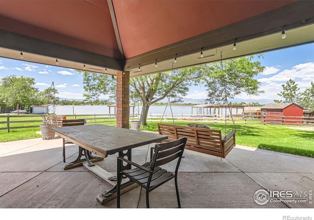 7975 Anchor Dr, Longmont, CO 80504 - view of patio / terrace with outdoor dining area and a water view