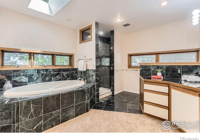 7975 Anchor Dr, Longmont, CO 80504 - full bathroom featuring a garden tub, a skylight, a stall shower, and recessed lighting