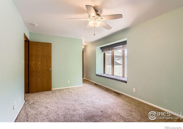 7975 Anchor Dr, Longmont, CO 80504 - carpeted spare room with ceiling fan and a smoke detector