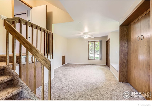 7975 Anchor Dr, Longmont, CO 80504 - unfurnished living room with carpet floors, ceiling fan, and stairs